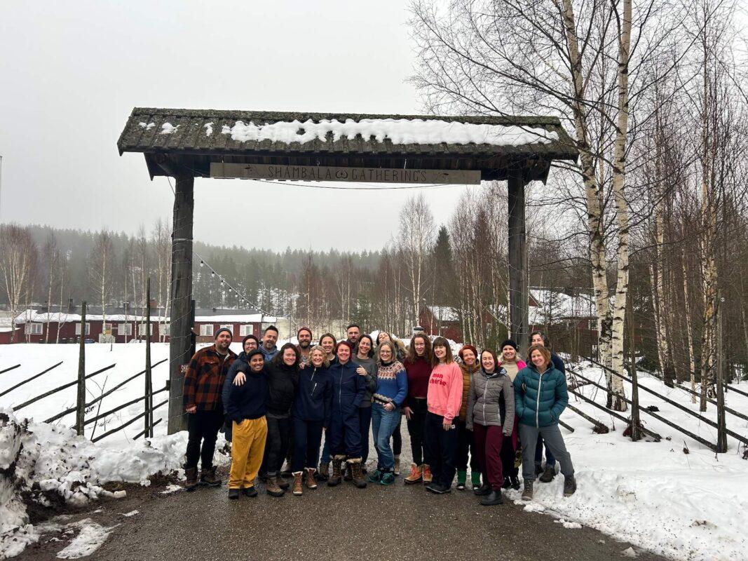 Group of retreat participants gathered at the entrance of Shambala Gatherings during the Wild Winter Retreat