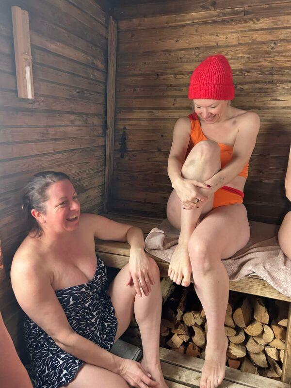 Retreat participants relaxing in a traditional sauna during the Wild Winter Retreat at Shambala Gatherings