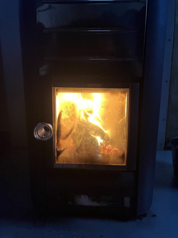 Wood-burning stove with a glowing fire creating a cozy atmosphere.